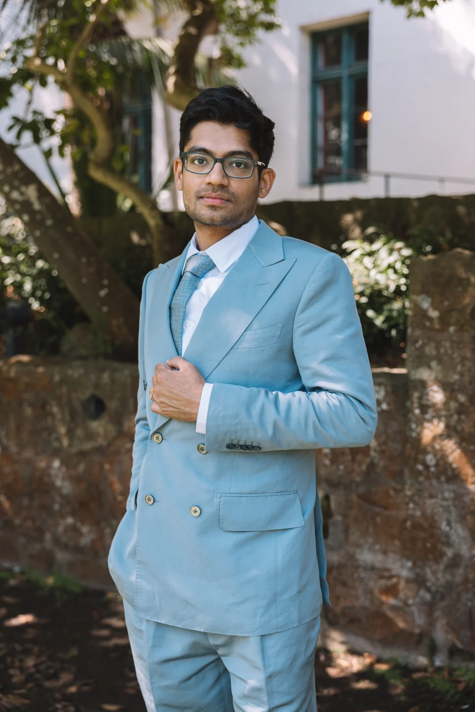 Joel Ruben Antony Moniz wearing a blue suit outdoors